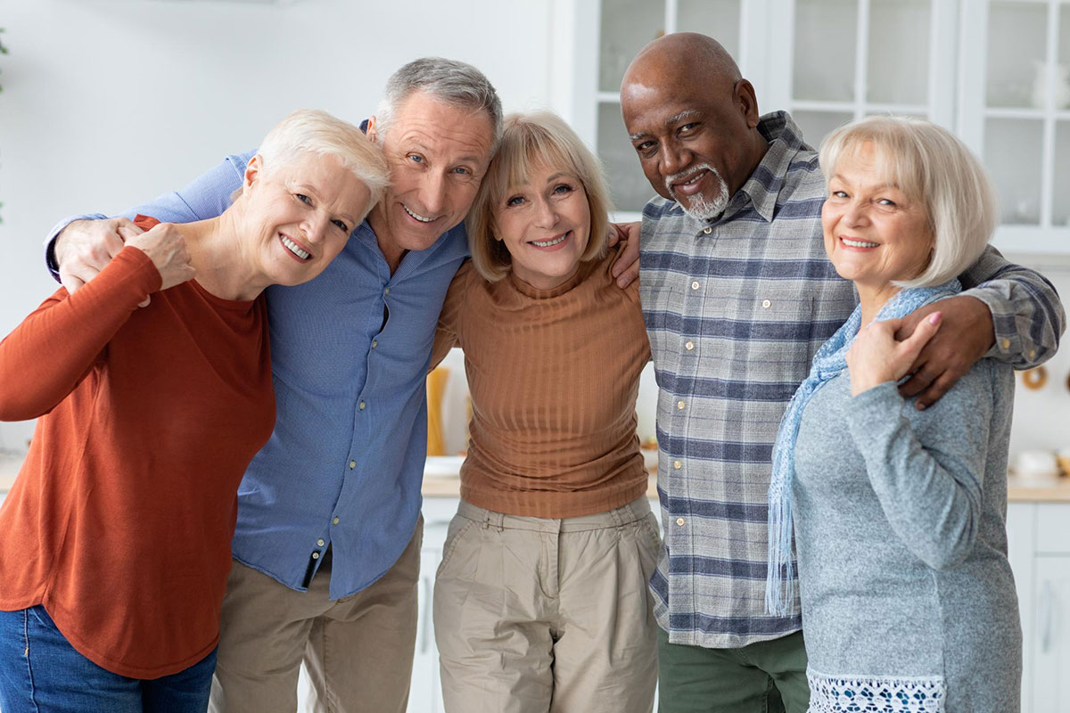 Five Happy Seniors are Sharing Community with a Group Hug in their New Custom Built Home
