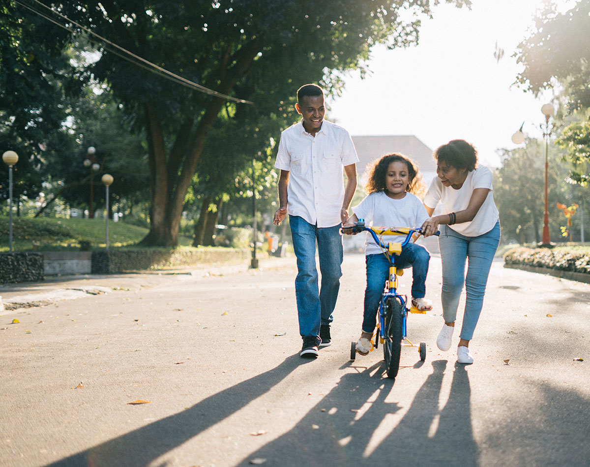 Parents with young child on a bike in the street