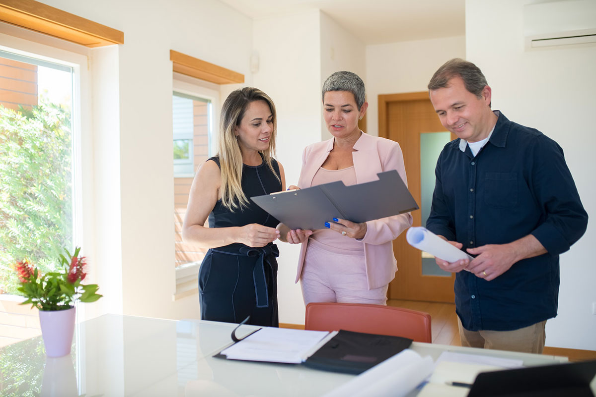A real estate agent and her clients prepare an offer on a home.
