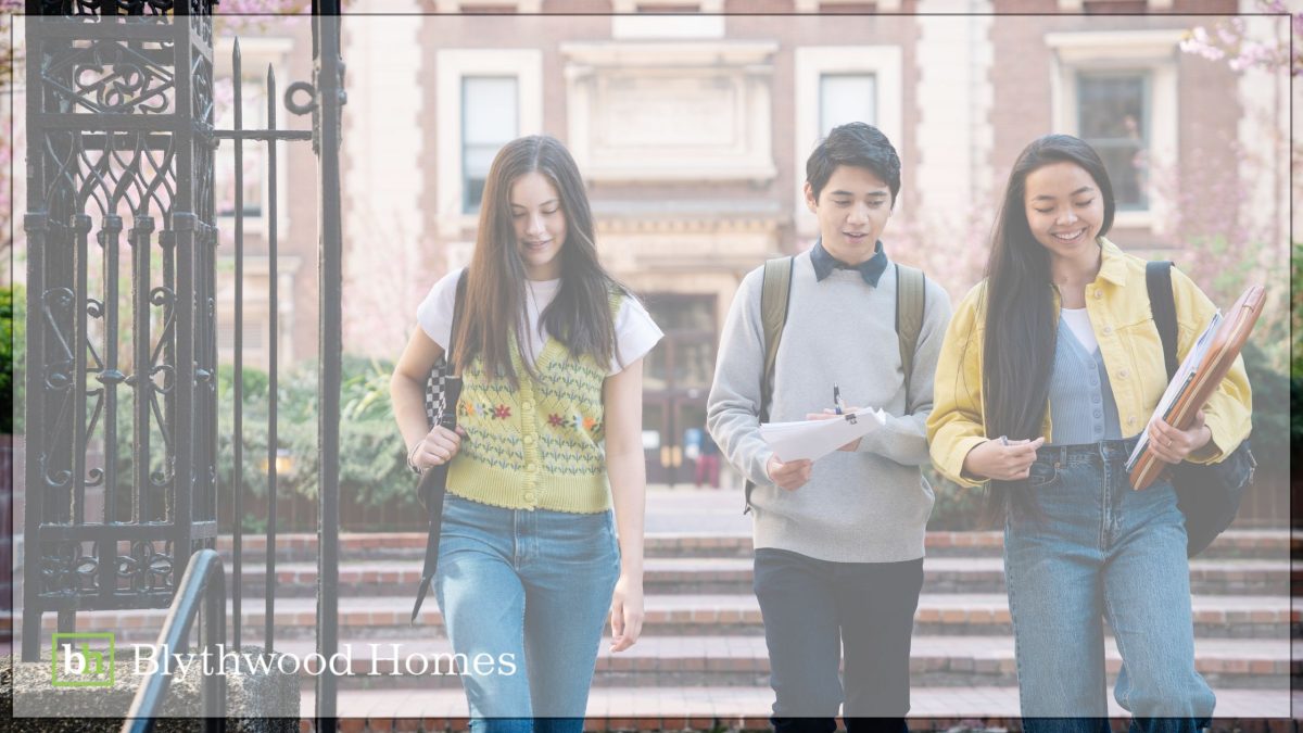 Three young students walk together outside a university campus in spring, representing the strong educational appeal of the Niagara region for next-gen Canadians, supported by Blythwood Homes.
